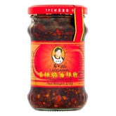 Laoganma - Crispy Chilli In Oil - 210g comes in a jar with a red lid and yellow label featuring a woman’s portrait. This spicy condiment brings bold flavor to any dish.